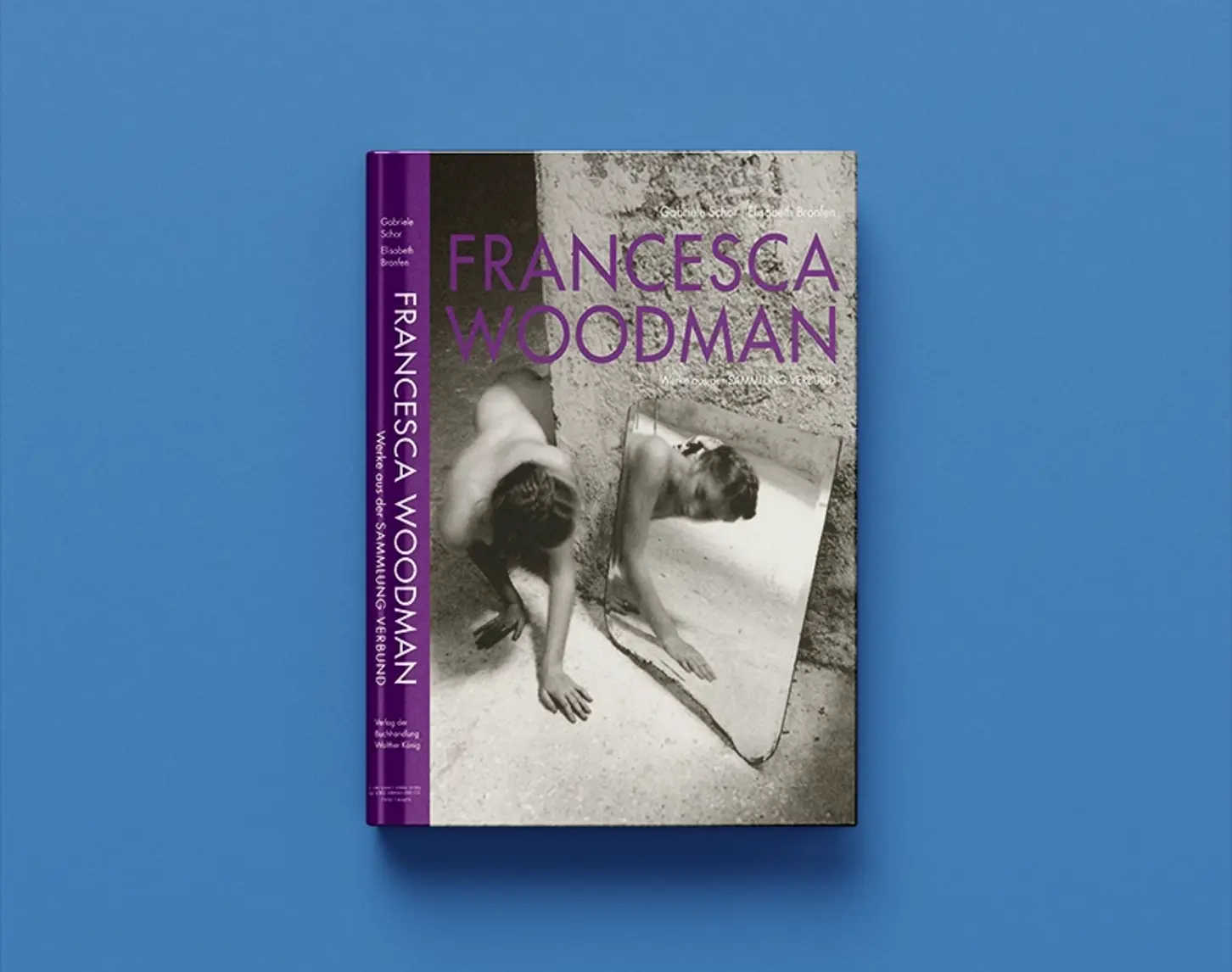 We see Francesca Woodman's catalog raisonné from 2014. The font is in violet. The cover features a black and white photograph of a woman in a rough concrete setting and her reflection in a large shard of mirror.