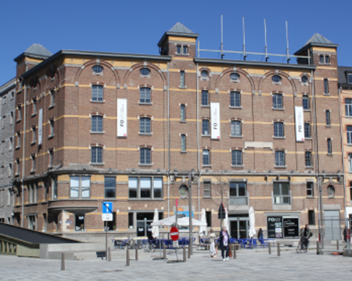 We see a brown brick building in the sunshine.